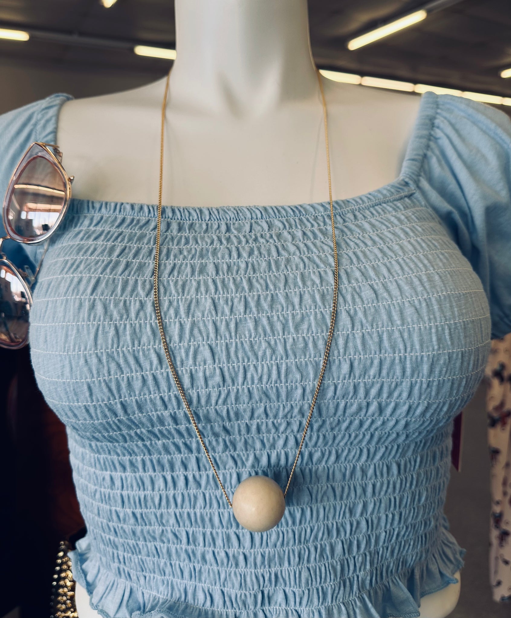 long Gold necklace with large cream bead